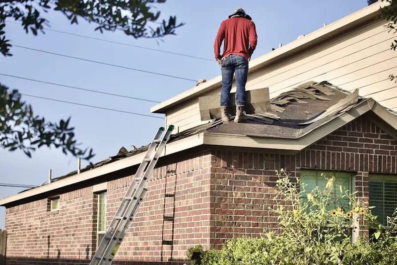 Professional roofer working on a residential roof in Lucketts